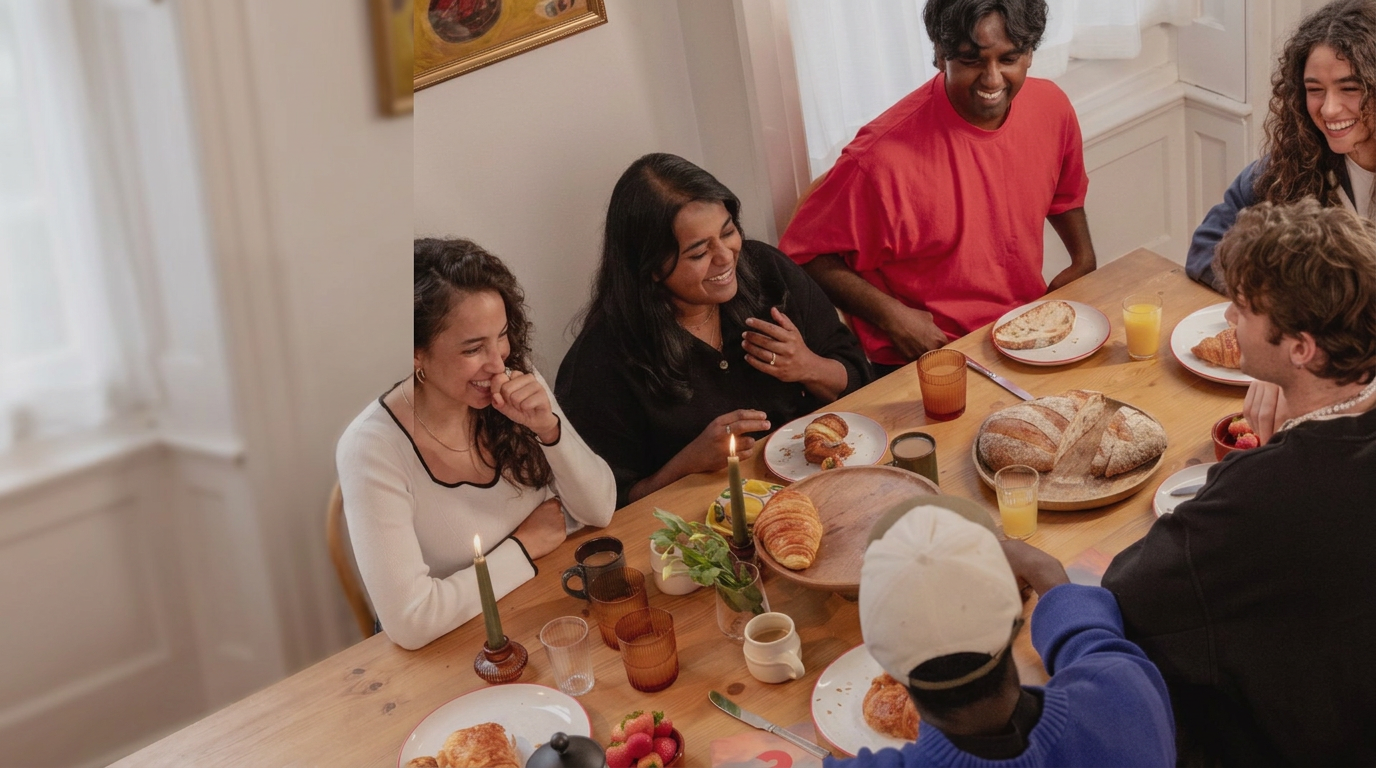 Friends laughing and sharing a meal around a table